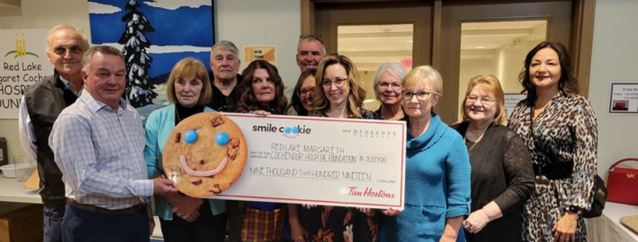 Admin Holding a smile-cookie cheque